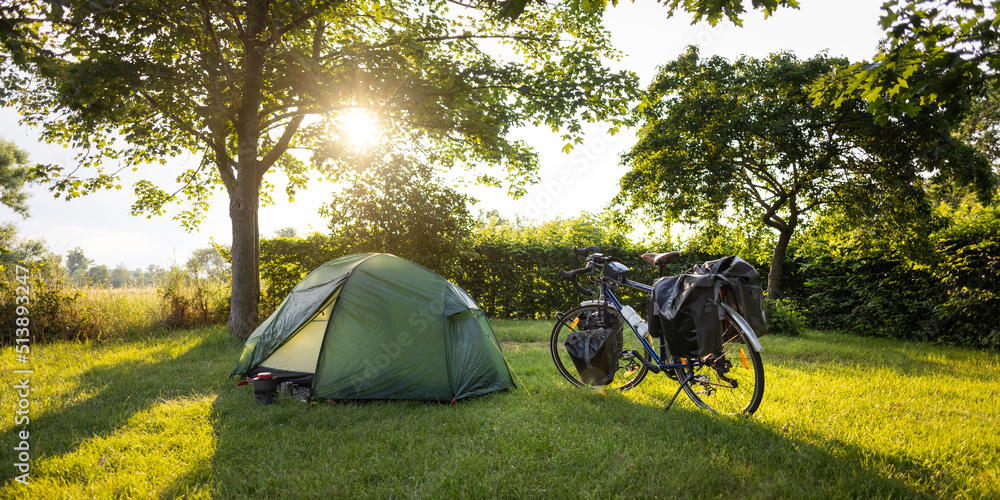 Camping spot on a bikepacking tour at sunset - obrazy, fototapety, plakaty 