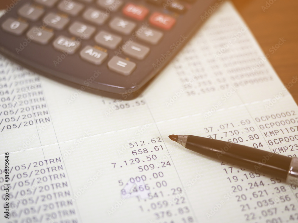 Close up pen on book banking statement,Calculator on the table Close up pen on book banking statement,Calculator on the table
