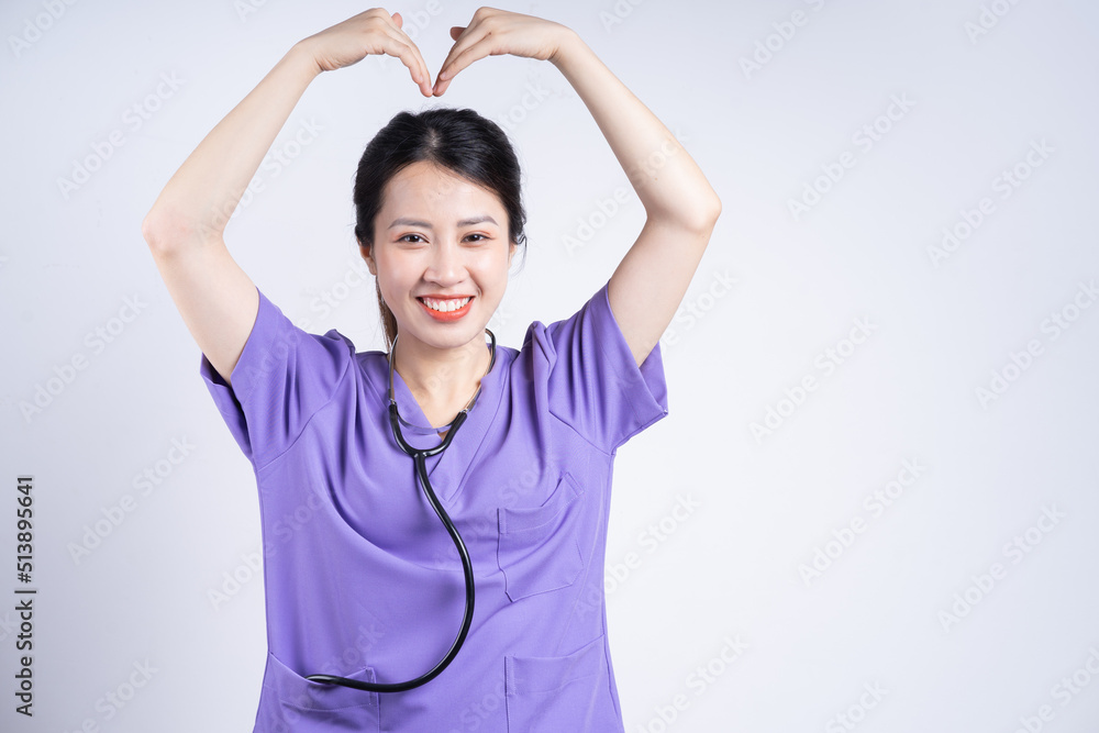 Portrait of young Asian nurse on white background Portrait of young Asian nurse on white background