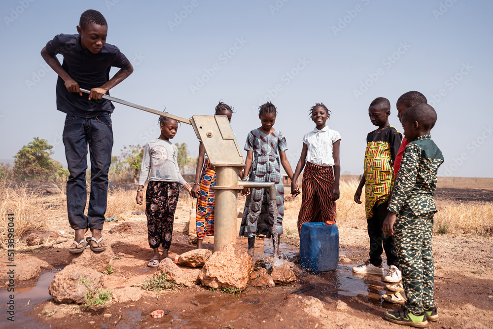 African Children Playing At The Village Water Pump Stock Photo