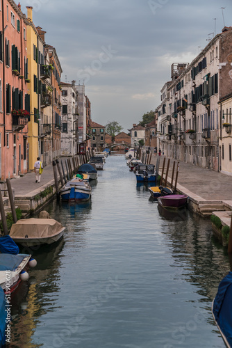 Typical street canal and colorful buildings in Venice, Italy