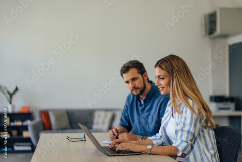 Side view of a businessman and businesswoman, using modern technology.