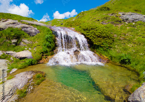 Monte Gorzano, Italy - The highest peak in the mountain range named Monti della Laga, Lazio and Abruzzo region, with Cento Fonti waterfalls and hikers who practice trekking in altitude. photo