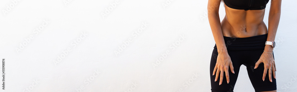 Young slim woman is doing breathing exercises. Home sports training. Belly vacuum. Banner with place for text. Healthy lifestyle. Vacuum yoga gymnastics for the abdomen. Nauli. Press muscle. Young slim woman is doing breathing exercises. Home sports training. Belly vacuum. Banner with place for text. Healthy lifestyle. Vacuum yoga gymnastics for the abdomen. Nauli. Press muscle.