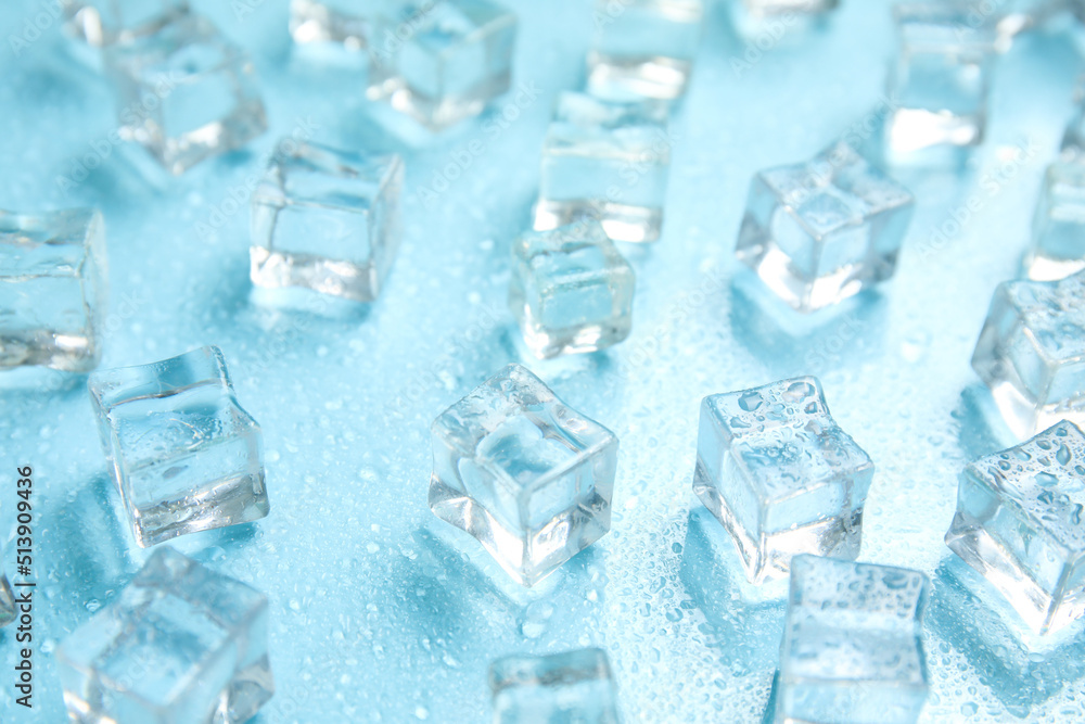 Ice cubes and water drops on turquoise background. Ingredient for refreshing drink Ice cubes and water drops on turquoise background. Ingredient for refreshing drink