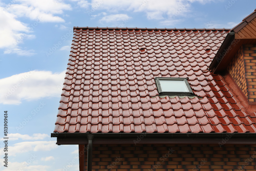Fototapeta premium Beautiful house with red roof against blue sky