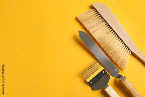 Beekeeping tools on yellow background  flat lay. Space for text