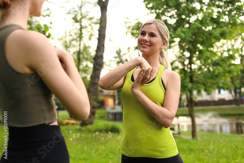 Women doing morning exercise together in park