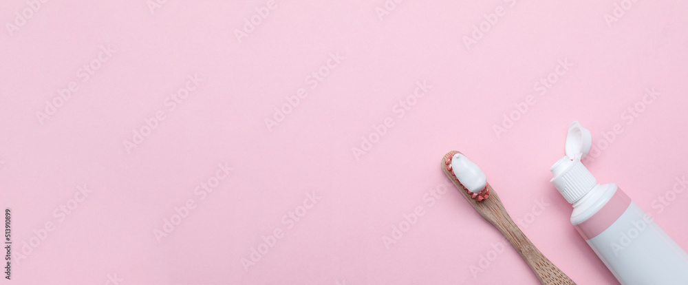 Tube and brush with toothpaste on light pink background, flat lay with space for text. Banner design Tube and brush with toothpaste on light pink background, flat lay with space for text. Banner design