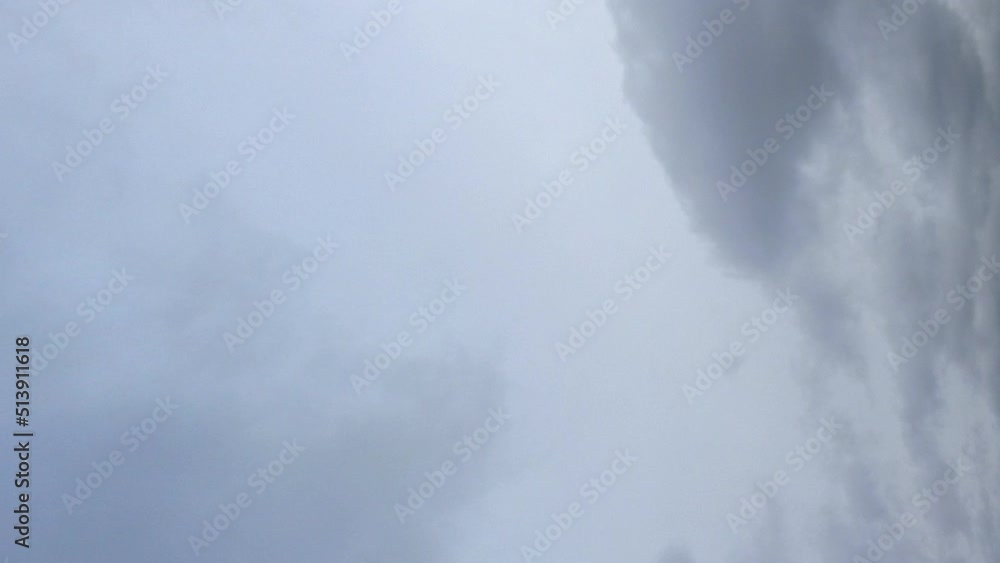 Vertical format: Dark heavy overcast clouds in grey sky time lapse Vertical format: Dark heavy overcast clouds in grey sky time lapse
