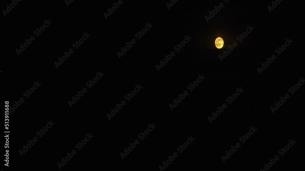 Waning Gibbous moon rises diagonally through clear black night sky Waning Gibbous moon rises diagonally through clear black night sky