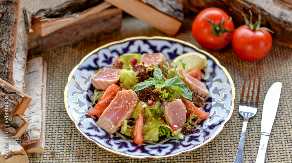 fresh salad with tuna on a patterned plate