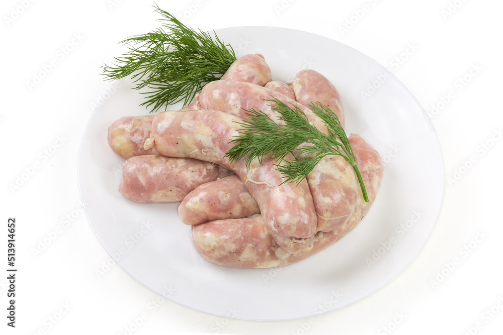 Raw chicken sausages with dill on dish on white background Raw chicken sausages with dill on dish on white background