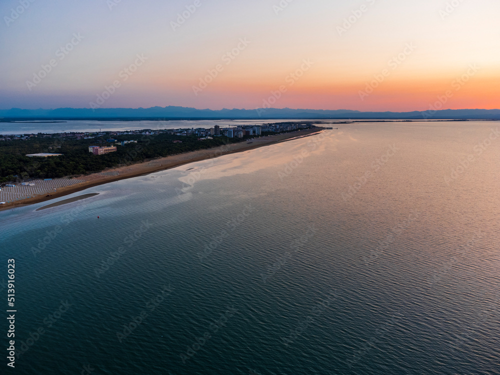 Sunrise in Lignano Sabbiadoro seen from above. From the sea to the lagoon, the city of holidays Sunrise in Lignano Sabbiadoro seen from above. From the sea to the lagoon, the city of holidays
