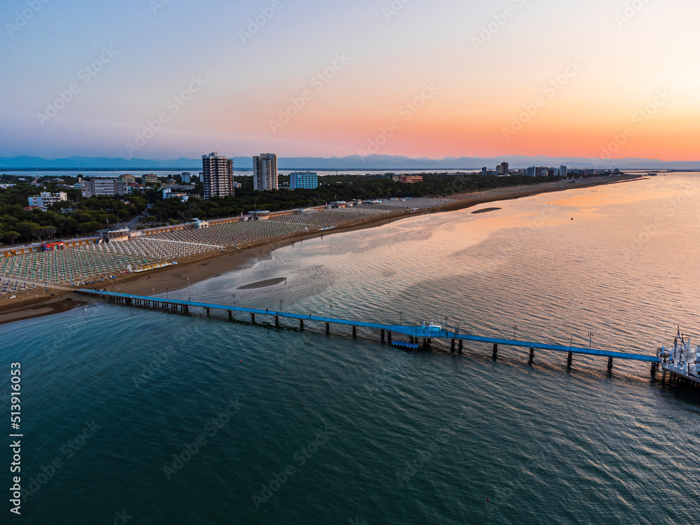 Obraz premium Sunrise in Lignano Sabbiadoro seen from above. From the sea to the lagoon, the city of holidays