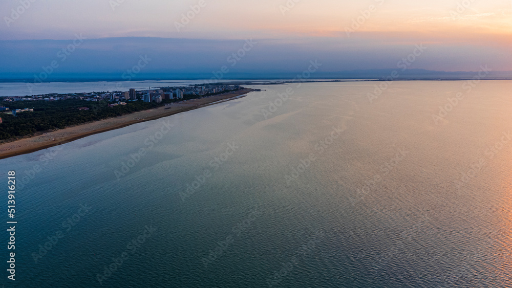 Sunrise in Lignano Sabbiadoro seen from above. From the sea to the lagoon, the city of holidays