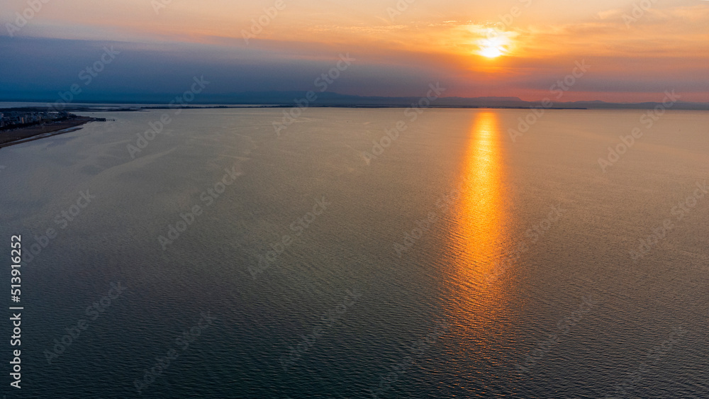 Obraz premium Sunrise in Lignano Sabbiadoro seen from above. From the sea to the lagoon, the city of holidays