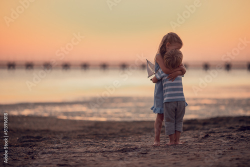 Canvastavla brother and sister love each other, little boy and girl hugs on the seashore on journey