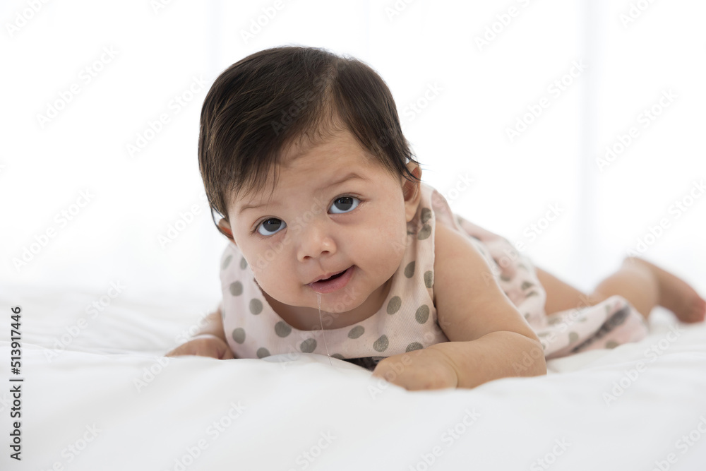 cute baby crawling on bed and drooling from mouth cute baby crawling on bed and drooling from mouth