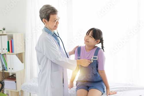 close up doctor, Asian doctor talk with children patient about disease symptom, doctor use stethoscope listening lung of patient, children health check up, happiness hospital photo