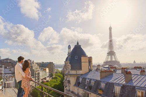 Shot of a young couple admiring the view from the balcony of an apartment overlooking The Eiffel Tower in Paris, France © AILA/peopleimages.com