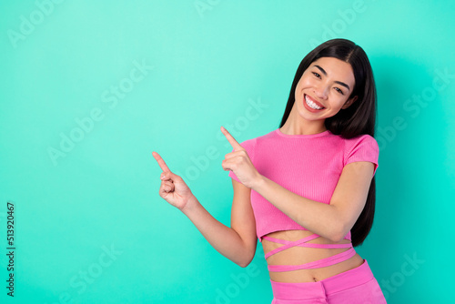 Photo of young attractive girl promote haircare products point fingers empty space isolated on teal color background