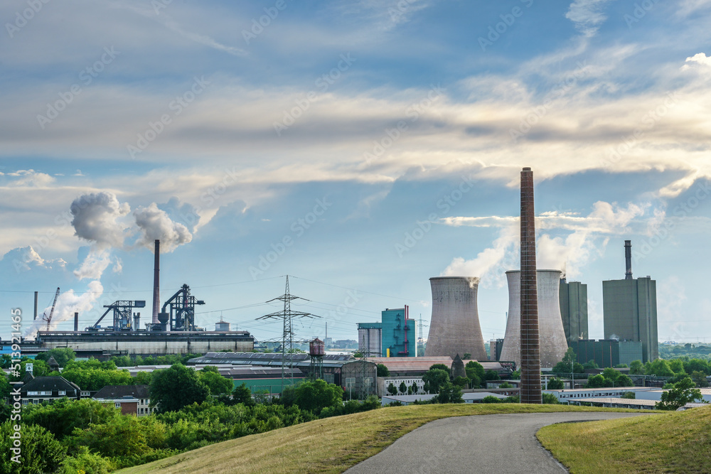 HKM, steelworks Krupp Mannesmann and power plant towers, heavy industry pollution using fossil energy in Duisburg, Germany, blue sky with clouds and copy space