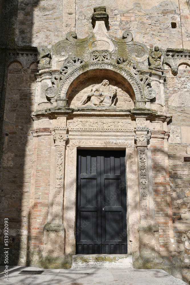 The entrance door into a medieval church in Miglionico, a historic town in the province of Matera in Italy.