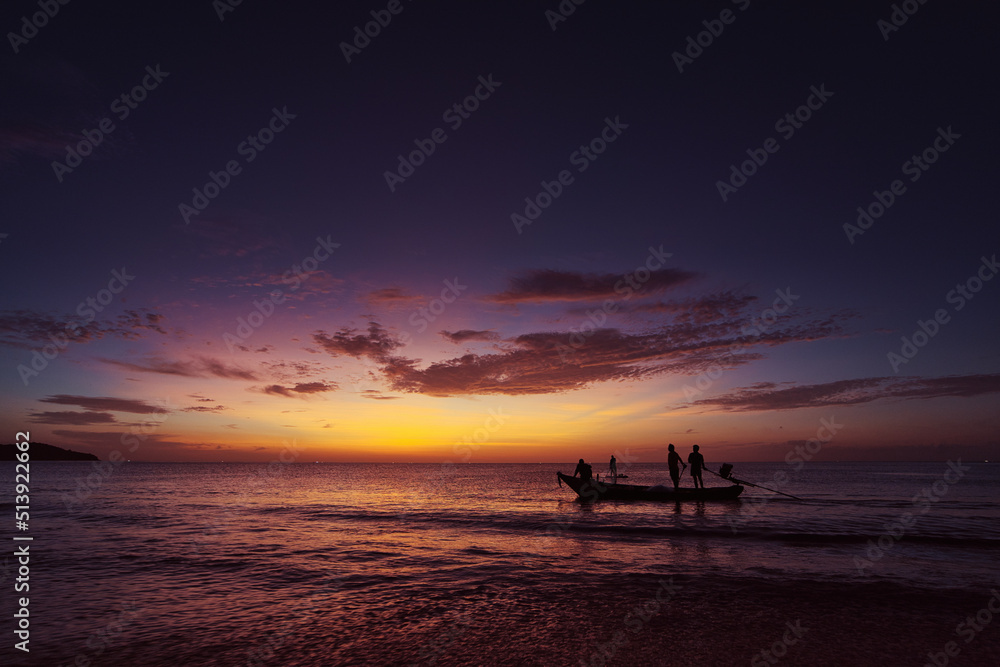 Travel by Thailand.  Colorful seascape with traditional fishing boat over beautiful sunset background.