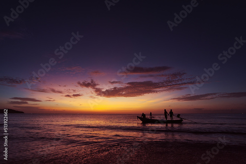 Travel by Thailand.  Colorful seascape with traditional fishing boat over beautiful sunset background. © luengo_ua