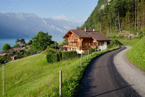 Beautiful view of the village on the lake shore in Swiss Alps mountains. Summer landscape.