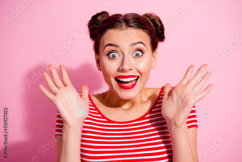 Portrait of impressed positive girl raise opened hands palms open mouth isolated on pink color background