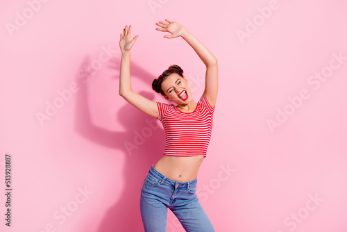 Photo of funny funky woman wear cropped t-shirt smiling dancing isolated pink color background