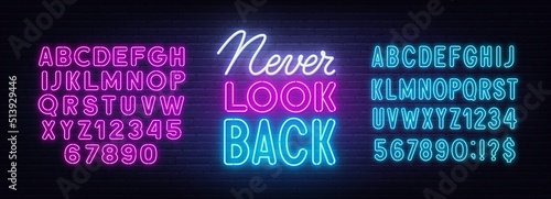Never Look Back neon sign on brick wall background.