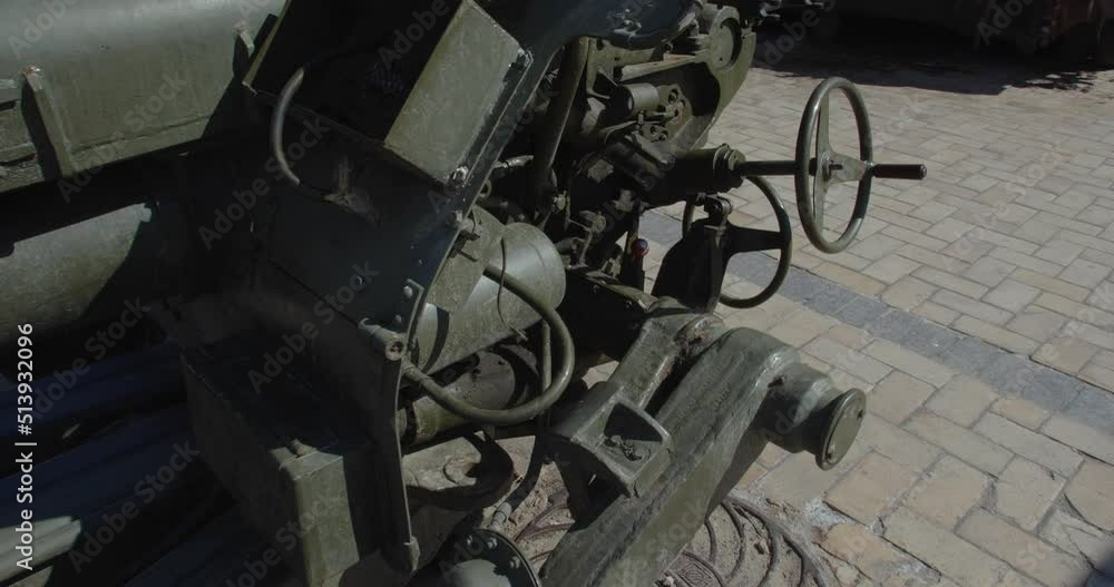 Tracking shot close up of Russian howitzer destroyed by Ukrainian artillery shelling, exhibited on city street for demonstration. Detail of rusty burnt military weapon D-30 Tracking shot close up of Russian howitzer destroyed by Ukrainian artillery shelling, exhibited on city street for demonstration. Detail of rusty burnt military weapon D-30