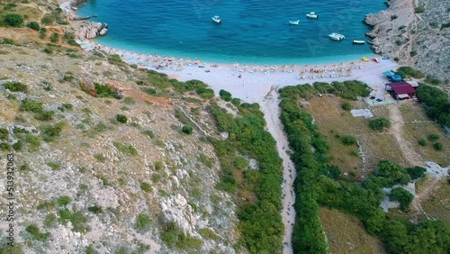 Aerial View Of Oprna Bay Beach With Umbrellas In Krk Island, Croatia. - tilt up photo