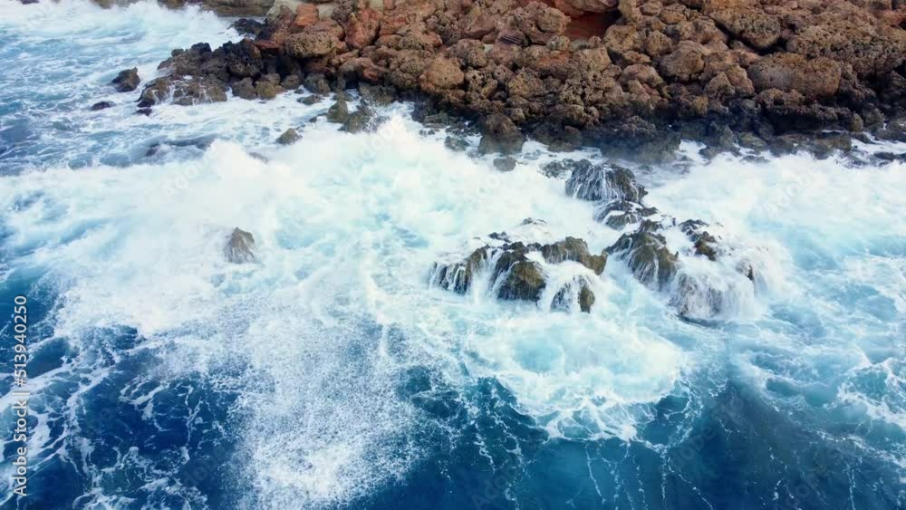 Sea waves washes the rocky shore, aerial top view. Cliffside Coastline with Blue Pure Water, Cyprus Sea waves washes the rocky shore, aerial top view. Cliffside Coastline with Blue Pure Water, Cyprus