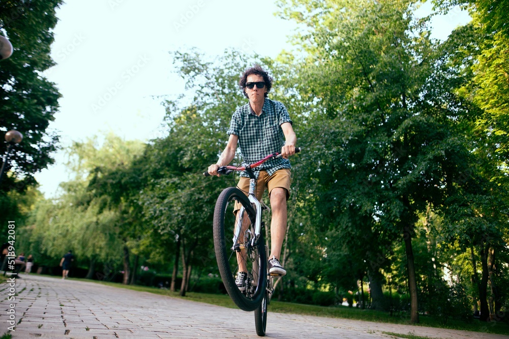 Cyclist riding in a city park.