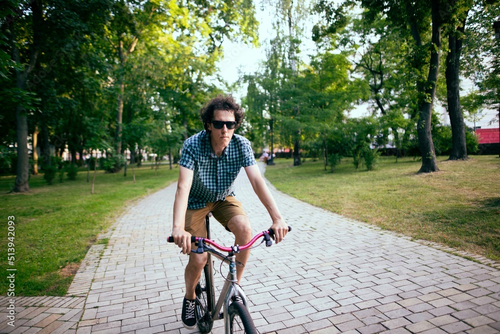 Cyclist riding in a city park.
