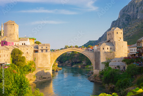 Fantastic Skyline of Mostar with the Mostar Bridge, houses and minarets, during sunny day. Location: Mostar, Old Town, Bosnia and Herzegovina, Europe photo