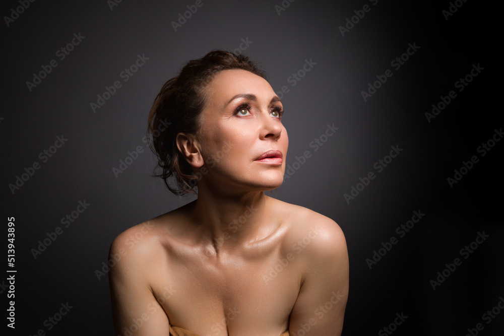 portrait of a sensual fifty year old woman on grey studio background portrait of a sensual fifty year old woman on grey studio background