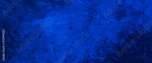 Blue textured paper or concrete wall background. Dark edges. copy space, dark blue rough grainy stone or concrete wall texture background.