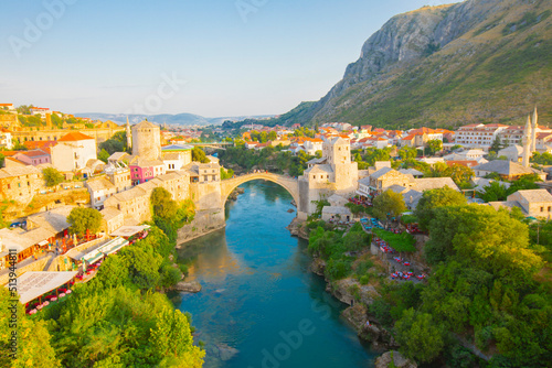 Fantastic Skyline of Mostar with the Mostar Bridge, houses and minarets, during sunny day. Location: Mostar, Old Town, Bosnia and Herzegovina, Europe