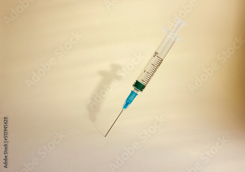 Syringe with a needle on a light background. vaccination. the concept of medicine and immunity. Vaccination against viral infections. Medicine Injection, drug. Copy space. Flat.