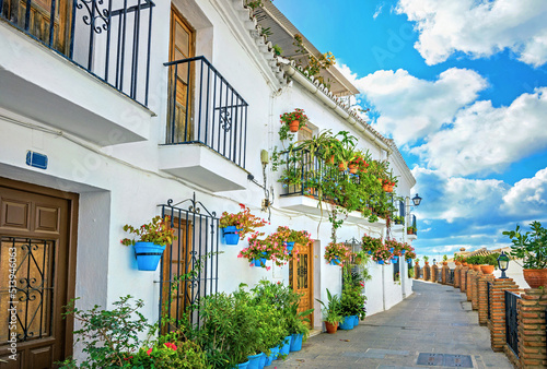 Facade of house with typical floral blue pots in Mijas. Malaga province, Andalusia, Spain
