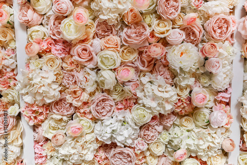 Flowers wall background with amazing pink and white roses, peonies and hydrangeas, wedding decorations, handmade.
