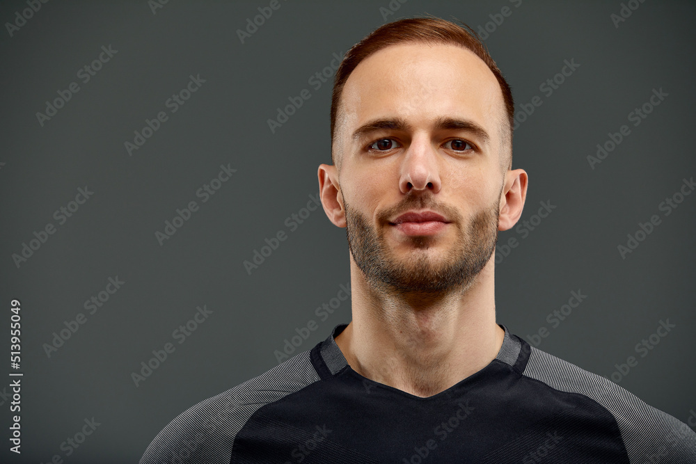 Studio male portrait of handsome powerful athletic man model with healthy muscular body in fashionable black tank top mock up poses on a gray background Studio male portrait of handsome powerful athletic man model with healthy muscular body in fashionable black tank top mock up poses on a gray background