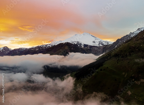 Mount Elbrus top view. Beautiful mountain landscape. Alpine climbing. Sunset in the mountains. The Caucasus is a region spanning Europe and Asia.Elbrus region. Aerial view to the mountains in summer.