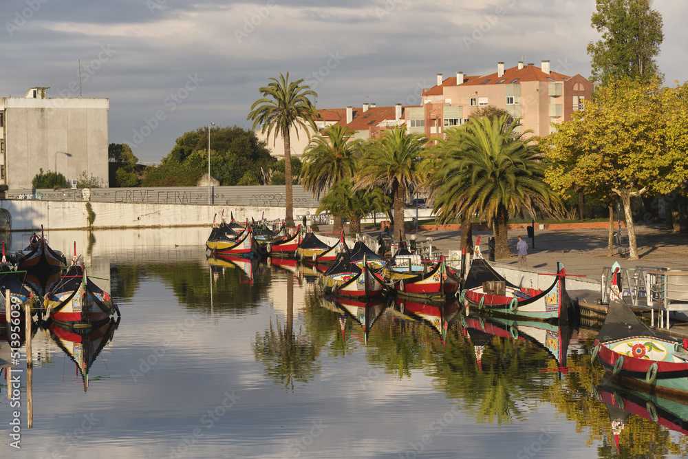 Traditional colorful boats called Moliceiros moored on the central canal in Aveiro, Portugal
