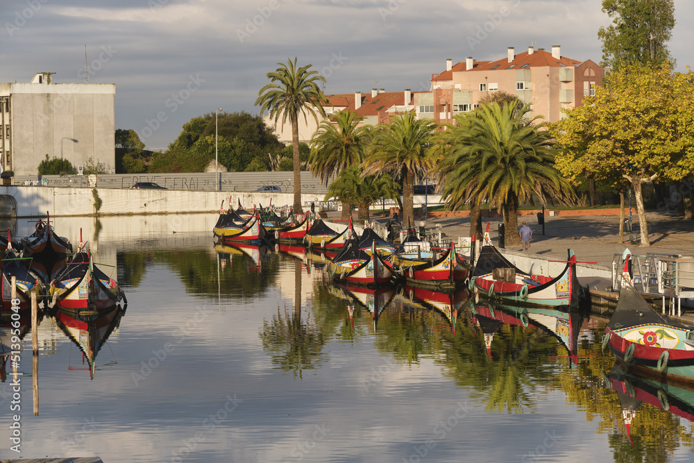Traditional colorful boats called Moliceiros moored on the central canal in Aveiro, Portugal